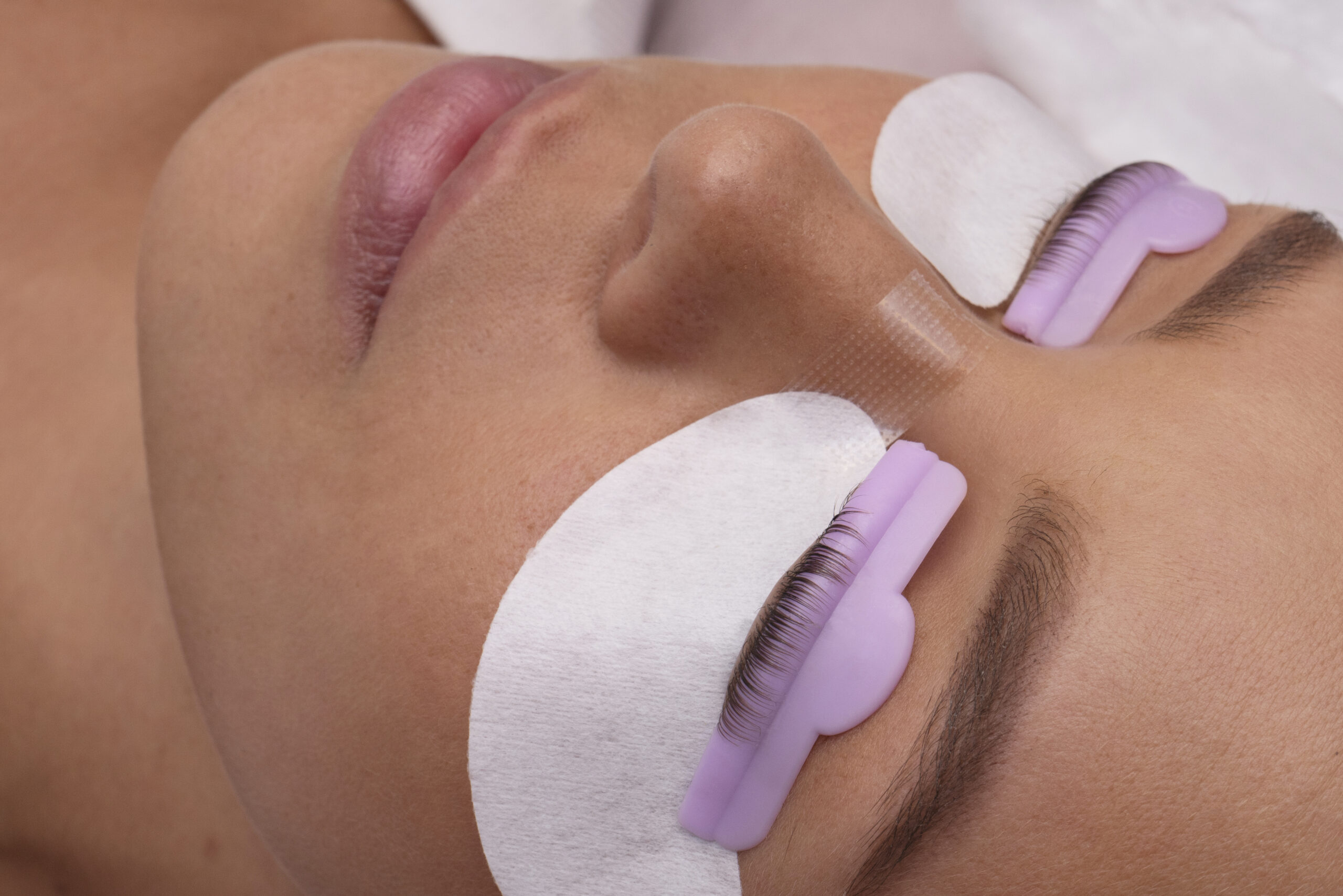 high-angle-young-woman-wearing-eye-patches-scaled